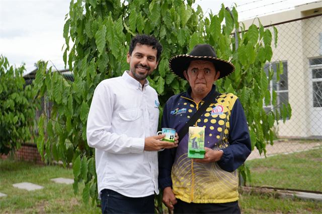 Handing over handmade products to a community project participant